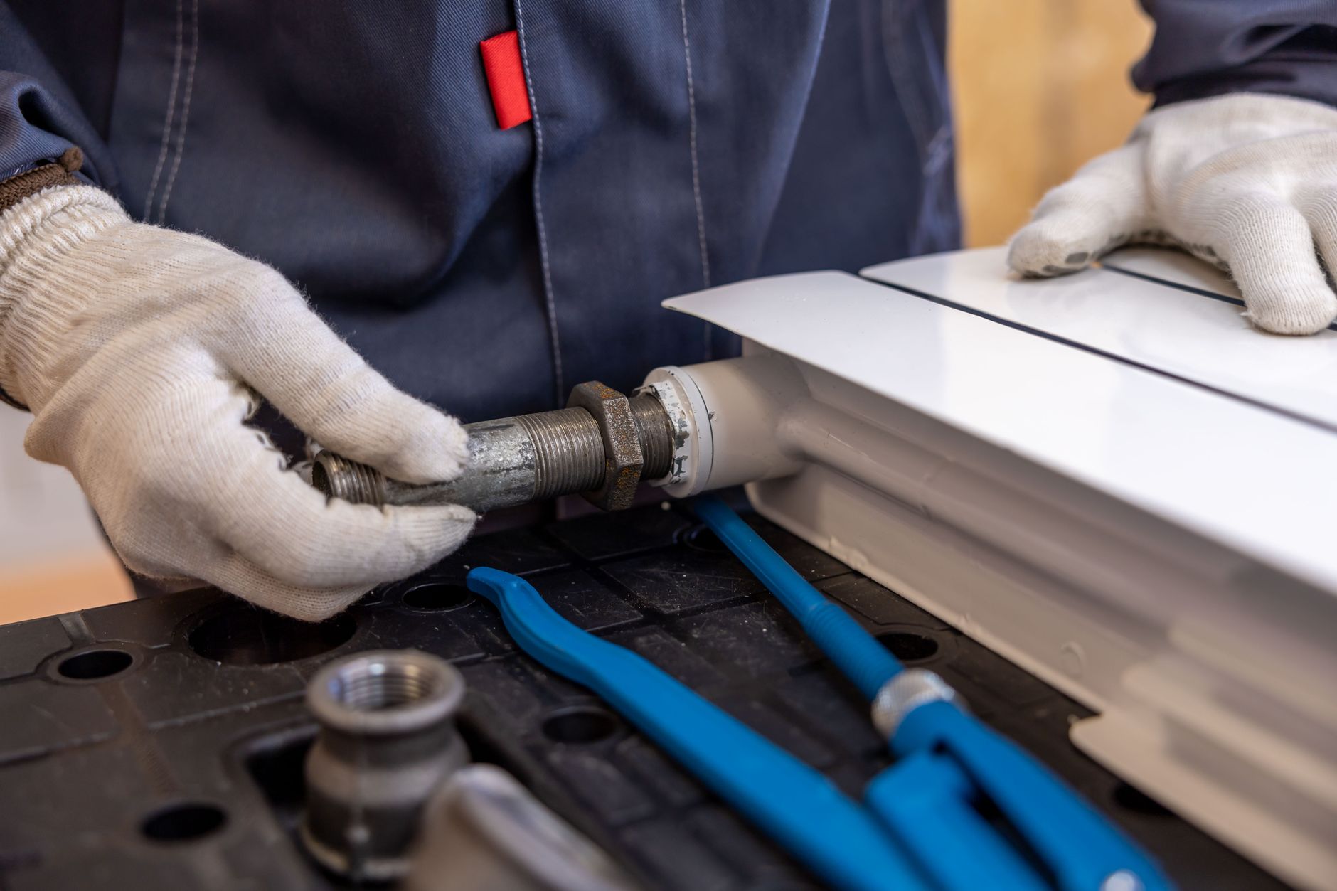 Combien gagne un plombier en — plombier travaillant sur des tuyaux